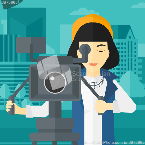 Image of Camerawoman with movie camera on a tripod.