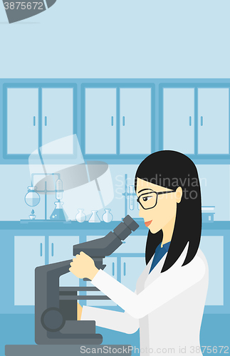 Image of Laboratory assistant with microscope.