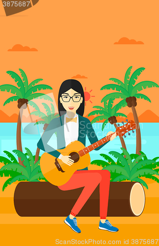 Image of Woman playing guitar.