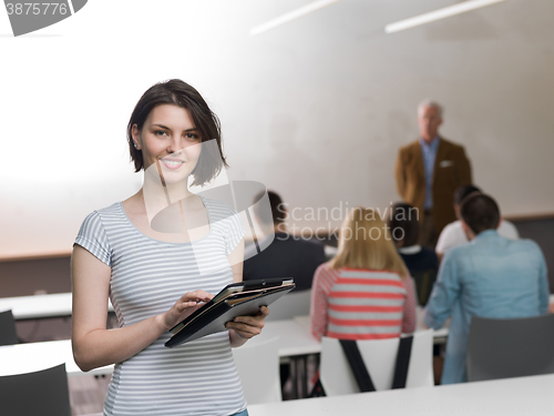 Image of portrait of happy female student in classroom