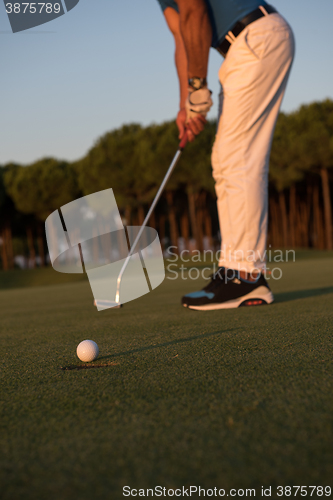 Image of golfer  hitting shot at golf course