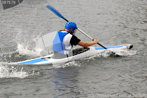 Image of Man racing in kayak