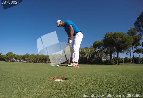 Image of golf player hitting shot at sunny day