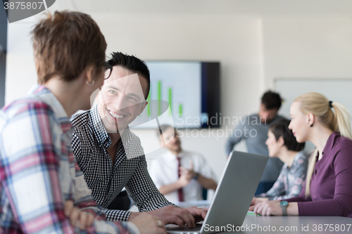 Image of young business couple working on laptop, businesspeople group on