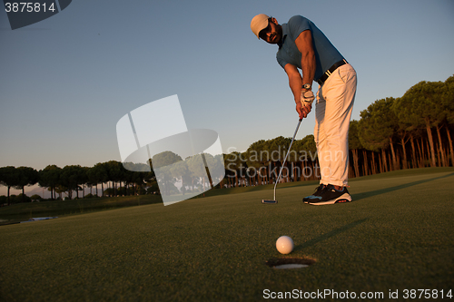 Image of golfer  hitting shot at golf course