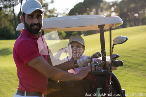 Image of couple in buggy on golf course