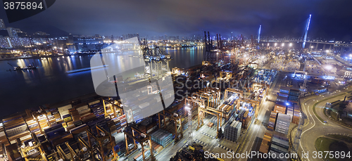 Image of Cargo ship and crane at port reflect on sea bay,