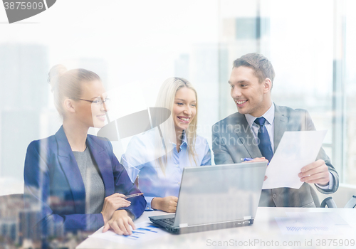 Image of business team with laptop having discussion