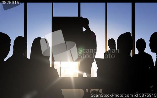 Image of business people silhouettes at meeting in office