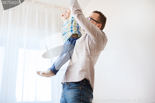 Image of father with son playing and having fun at home