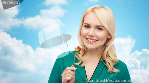 Image of smiling young woman eating vegetable salad