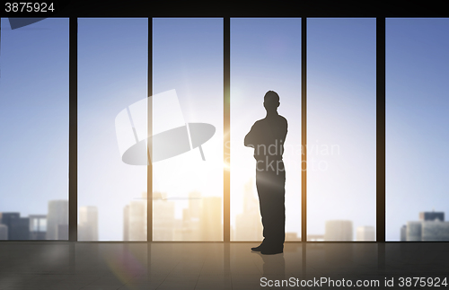Image of silhouette of business man over office background
