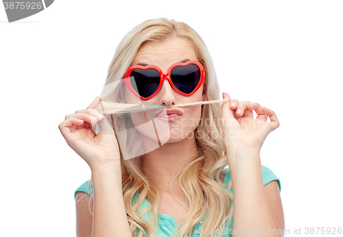 Image of happy young woman making mustache with her hair