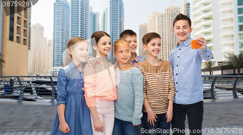 Image of happy children talking selfie by smartphone