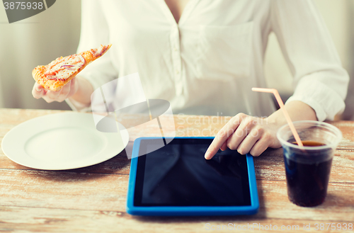 Image of close up of woman with tablet pc having dinner