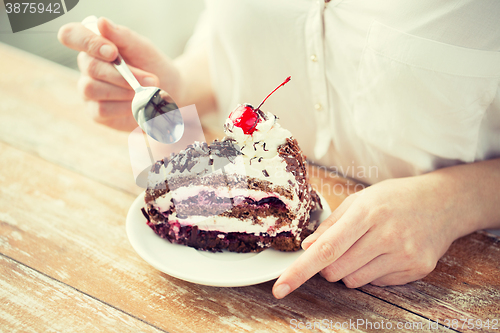 Image of close up of woman eating chocolate cherry cake