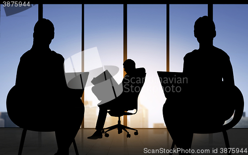 Image of silhouette of business people working at office