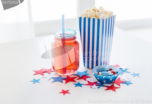 Image of drink and popcorn with candies on independence day