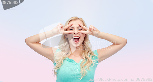 Image of smiling young woman or teenage girl showing peace