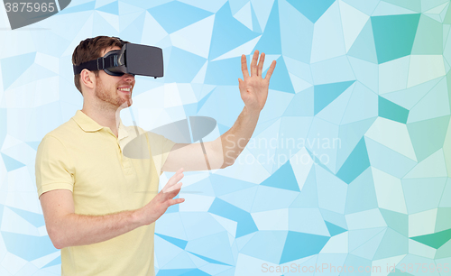 Image of happy man in virtual reality headset or 3d glasses