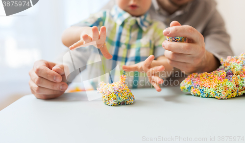 Image of father and son playing with ball clay at home