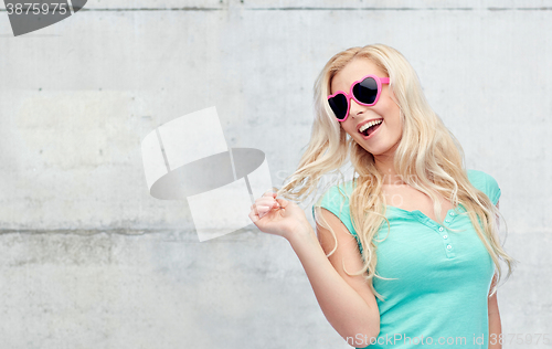 Image of happy young blonde woman or teenager in sunglasses