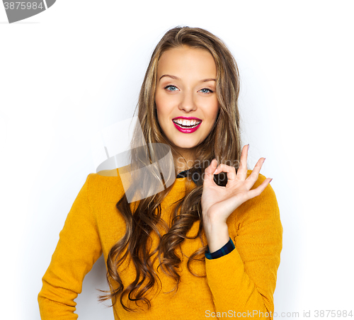 Image of happy young woman or teen showing ok hand sign