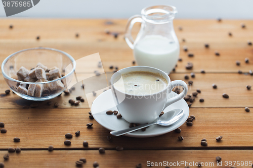 Image of close up coffee cup and grains on wooden table