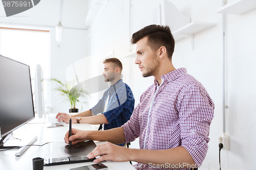 Image of man or designer with computer and tablet at office