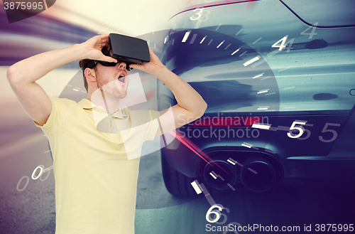 Image of man in virtual reality headset and car racing game