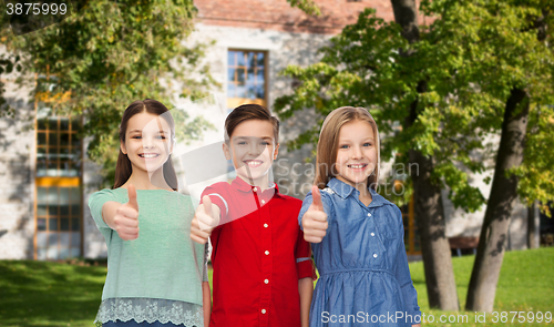 Image of happy boy and girls showing thumbs up