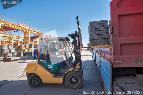 Image of Loading sidewalk products in transport