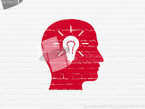 Image of Education concept: Head With Light Bulb on wall background
