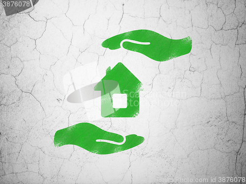 Image of Insurance concept: House And Palm on wall background