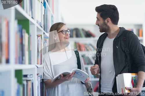 Image of students couple  in school  library