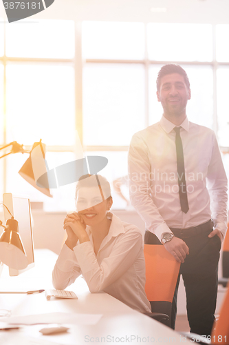 Image of business couple working together on project, sunrise in backgrou