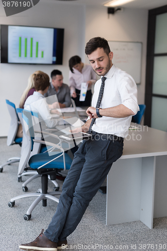 Image of young business man with tablet at office meeting room