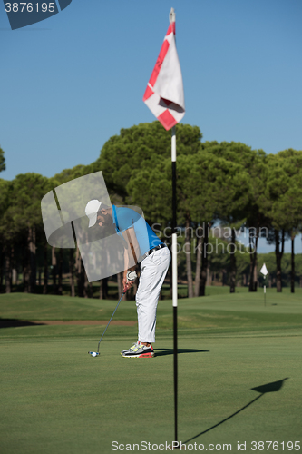Image of golf player hitting shot at sunny day