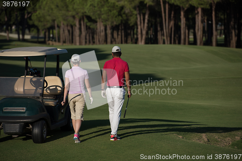 Image of couple walking on golf course