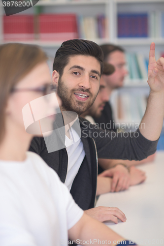 Image of group of students  raise hands up