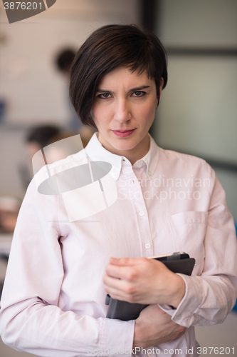 Image of hispanic businesswoman with tablet at meeting room