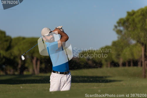 Image of pro golfer hitting a sand bunker shot