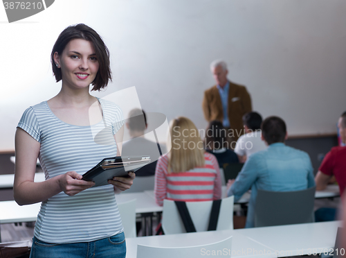 Image of portrait of happy female student in classroom