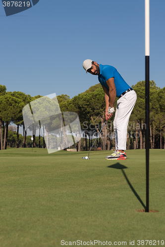 Image of golf player hitting shot at sunny day