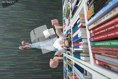 Image of female student study in library, using tablet and searching for 