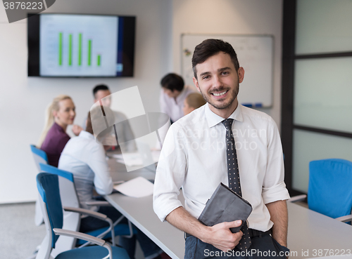 Image of young business man with tablet at office meeting room