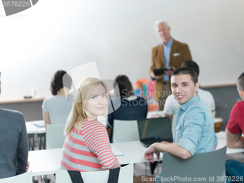 Image of teacher with a group of students in classroom