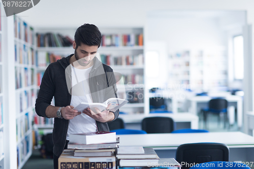 Image of portrait of student while reading book  in school library