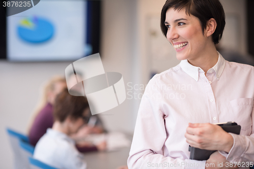 Image of hispanic businesswoman with tablet at meeting room