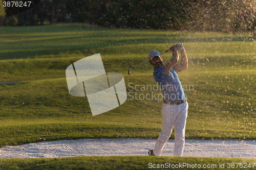 Image of golfer hitting a sand bunker shot on sunset